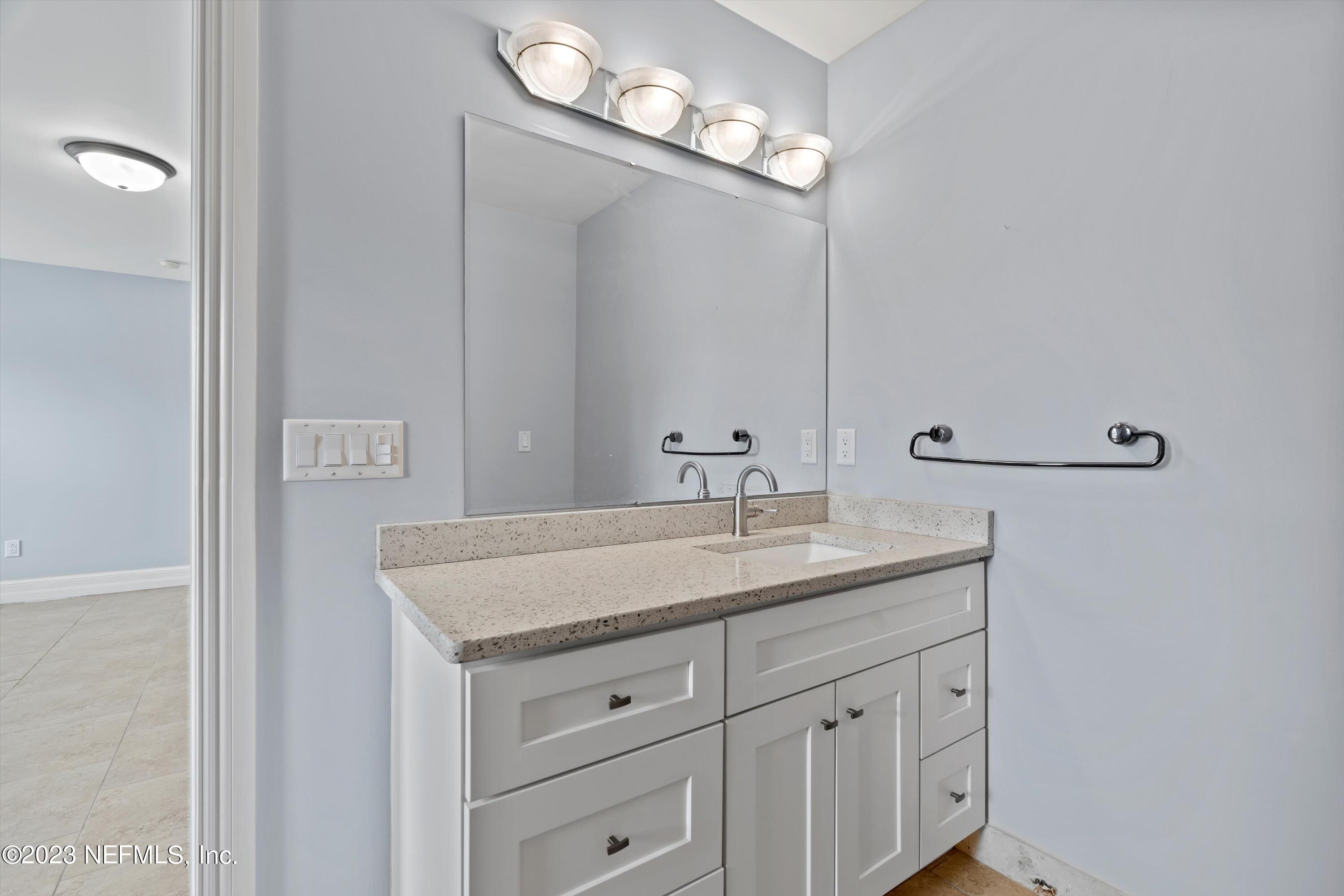 7936 Pine Lake Road Jacksonville, FL 32256 - Photo 29 of 52 a bathroom with a granite countertop sink and a mirror