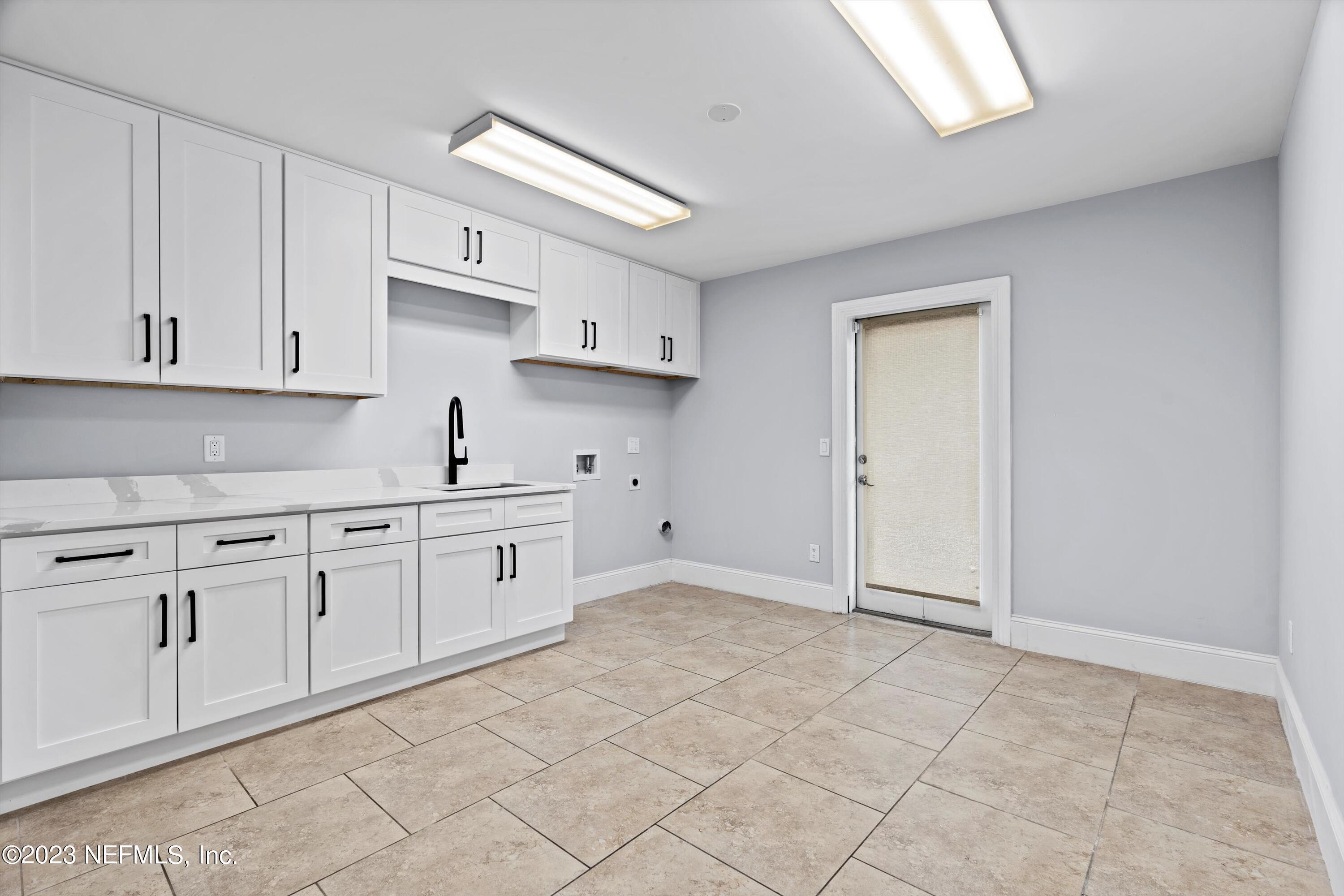 7936 Pine Lake Road Jacksonville, FL 32256 - Photo 37 of 52 a kitchen with granite countertop white cabinets and white appliances