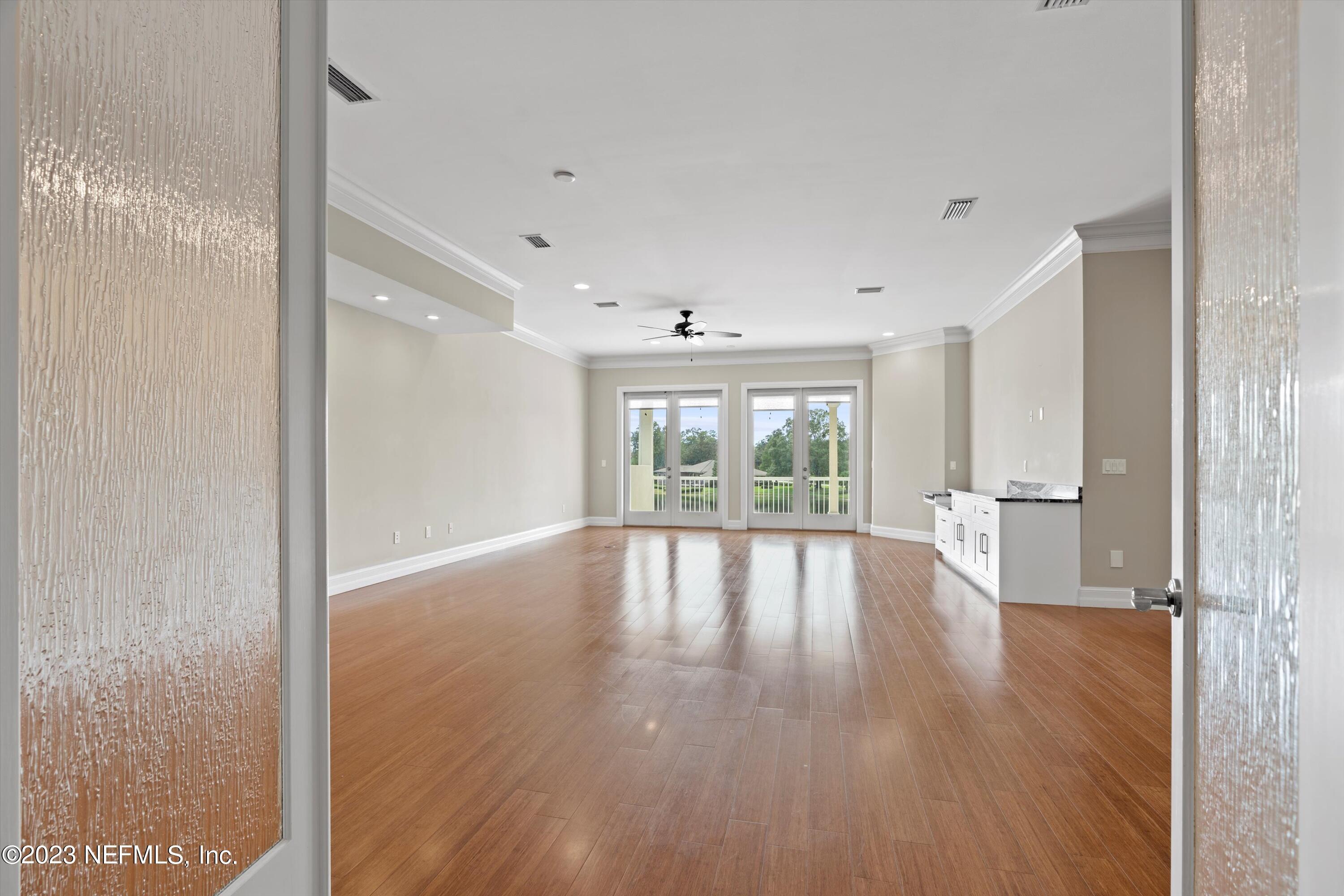 7936 Pine Lake Road Jacksonville, FL 32256 - Photo 39 of 52 a view of an empty room with wooden floor and a window
