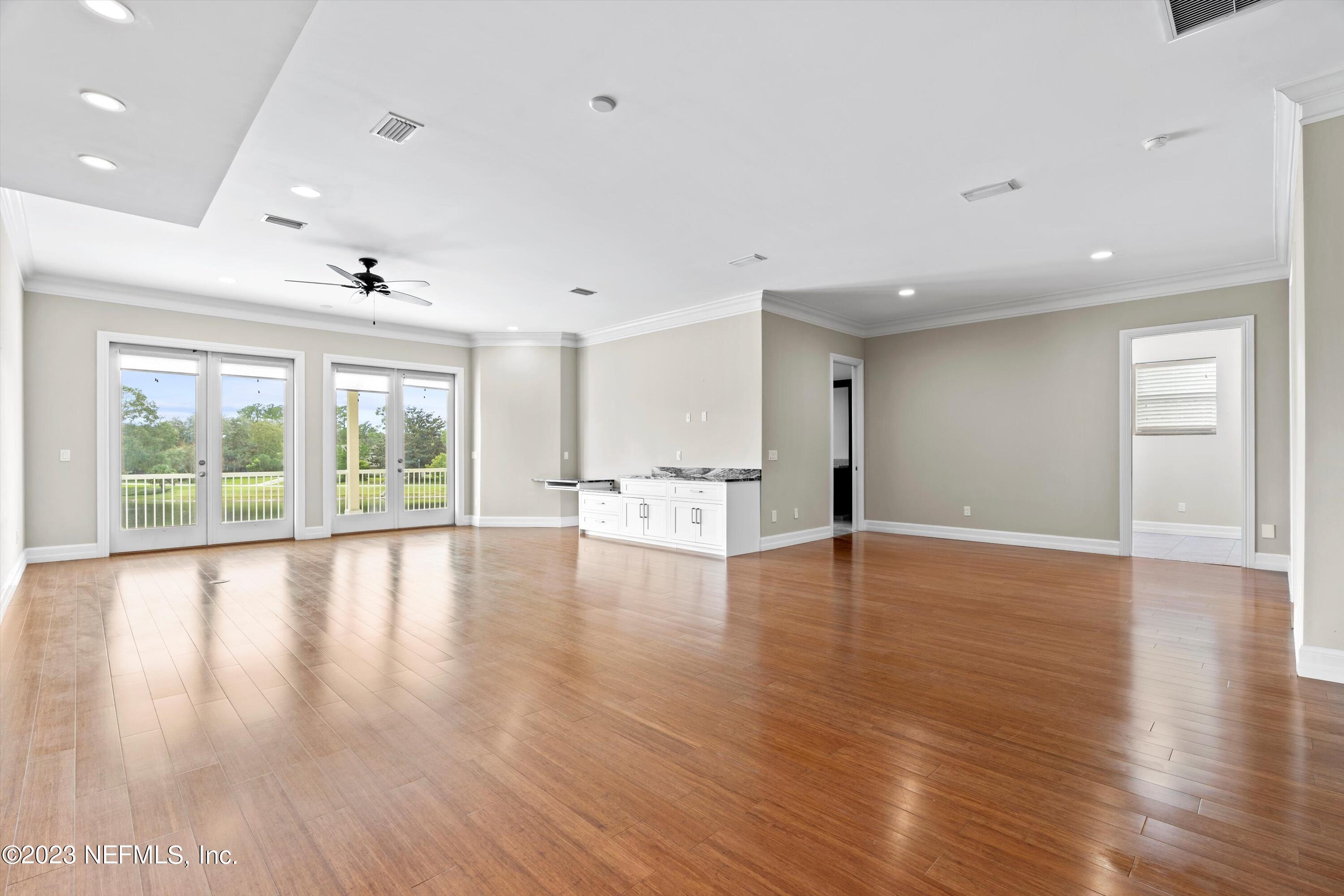7936 Pine Lake Road Jacksonville, FL 32256 - Photo 40 of 52 a view of an empty room with wooden floor and a window