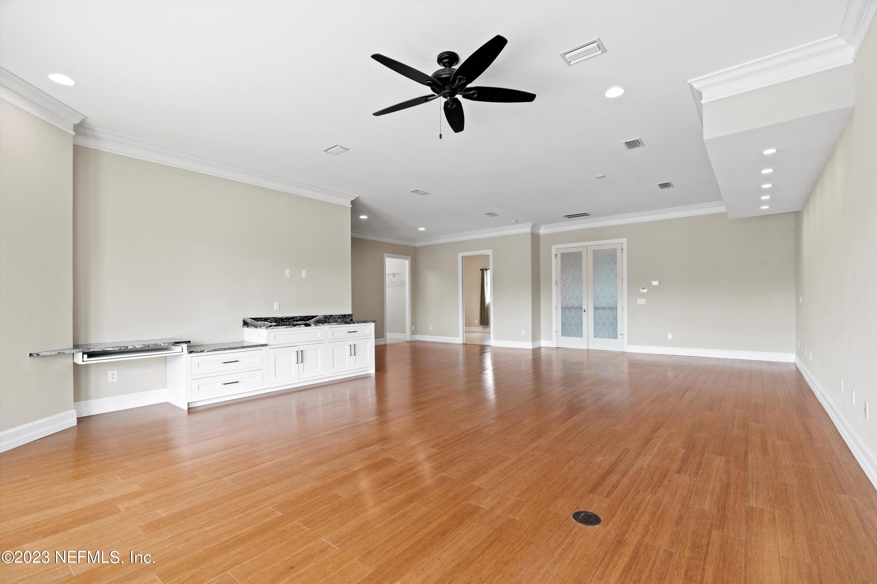 7936 Pine Lake Road Jacksonville, FL 32256 - Photo 42 of 52 a view of an empty room with window and wooden floor