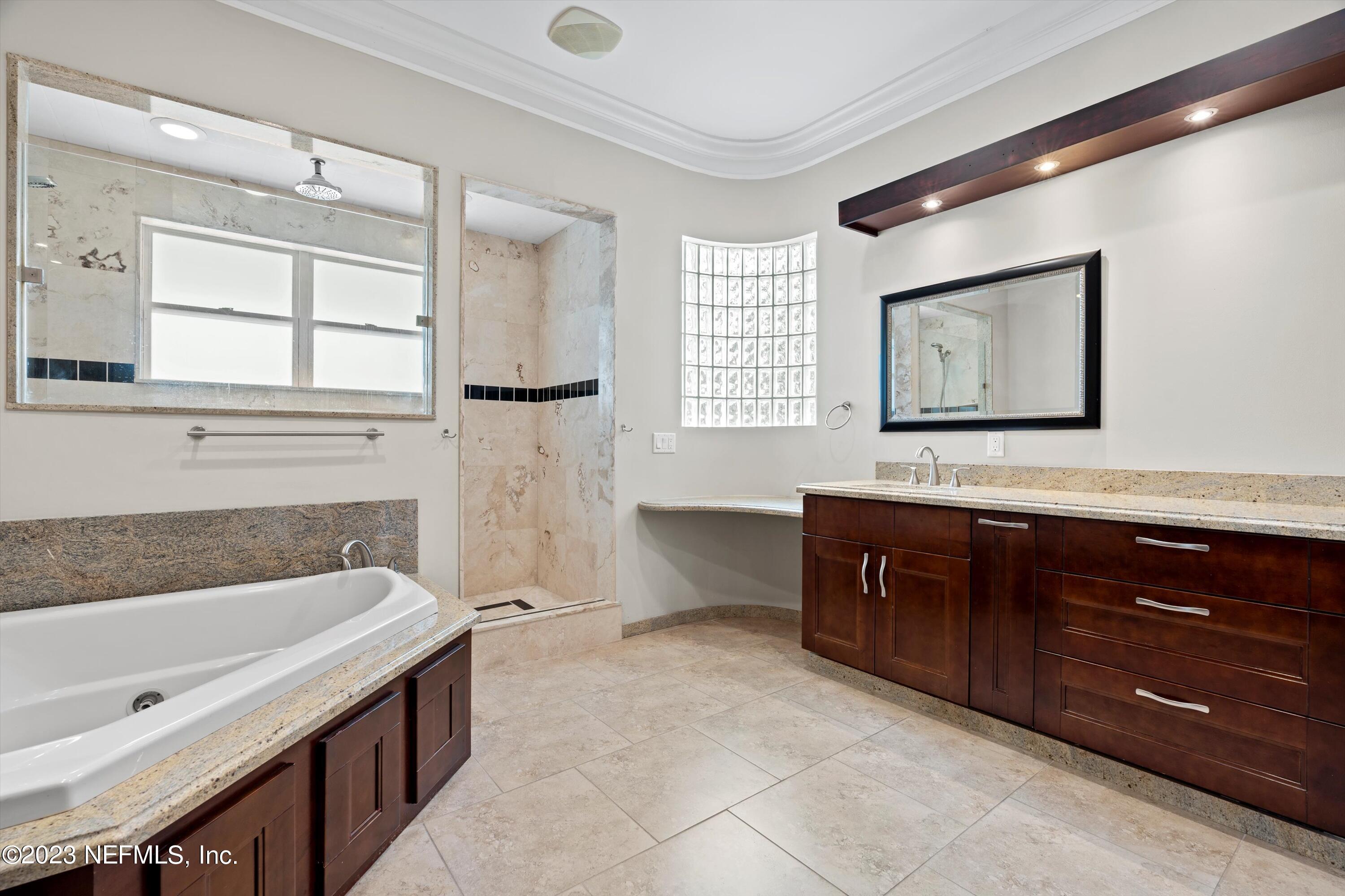 7936 Pine Lake Road Jacksonville, FL 32256 - Photo 46 of 52 a bathroom with a tub sink and mirror