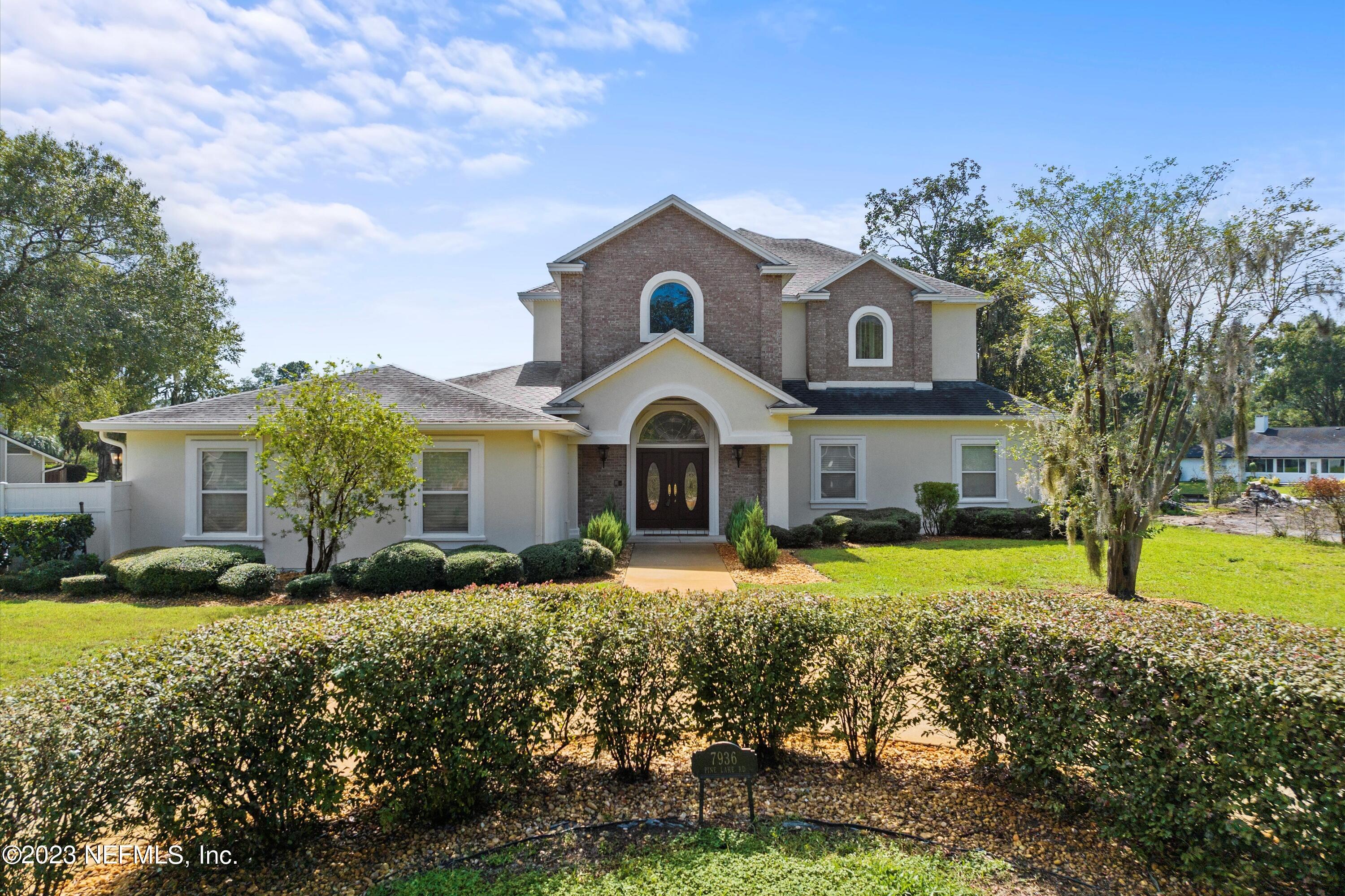 7936 Pine Lake Road Jacksonville, FL 32256 - Photo 6 of 52 a front view of a house with garden