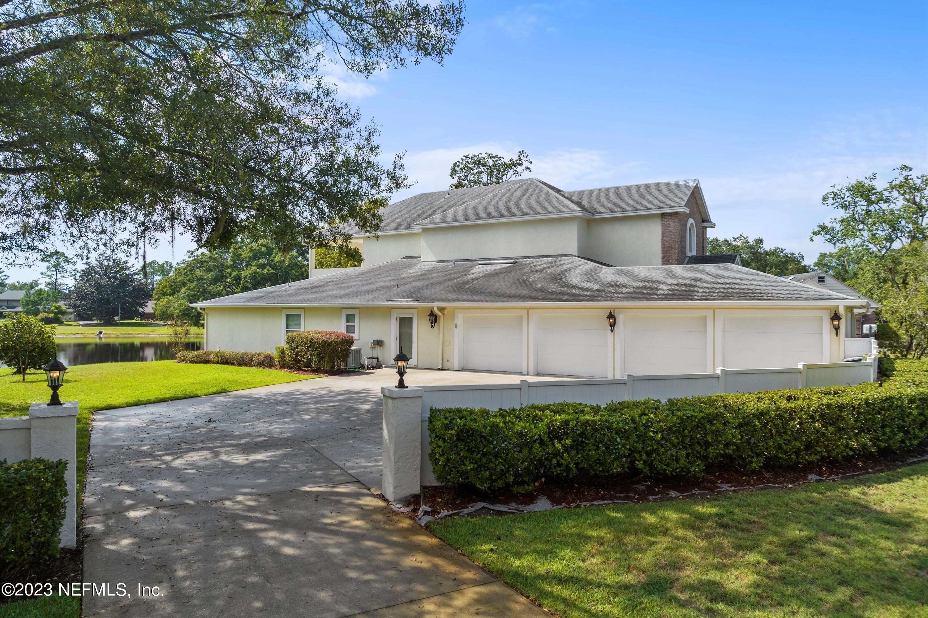 7936 Pine Lake Road Jacksonville, FL 32256 - Photo 7 of 52 a view of a house with a yard and potted plants