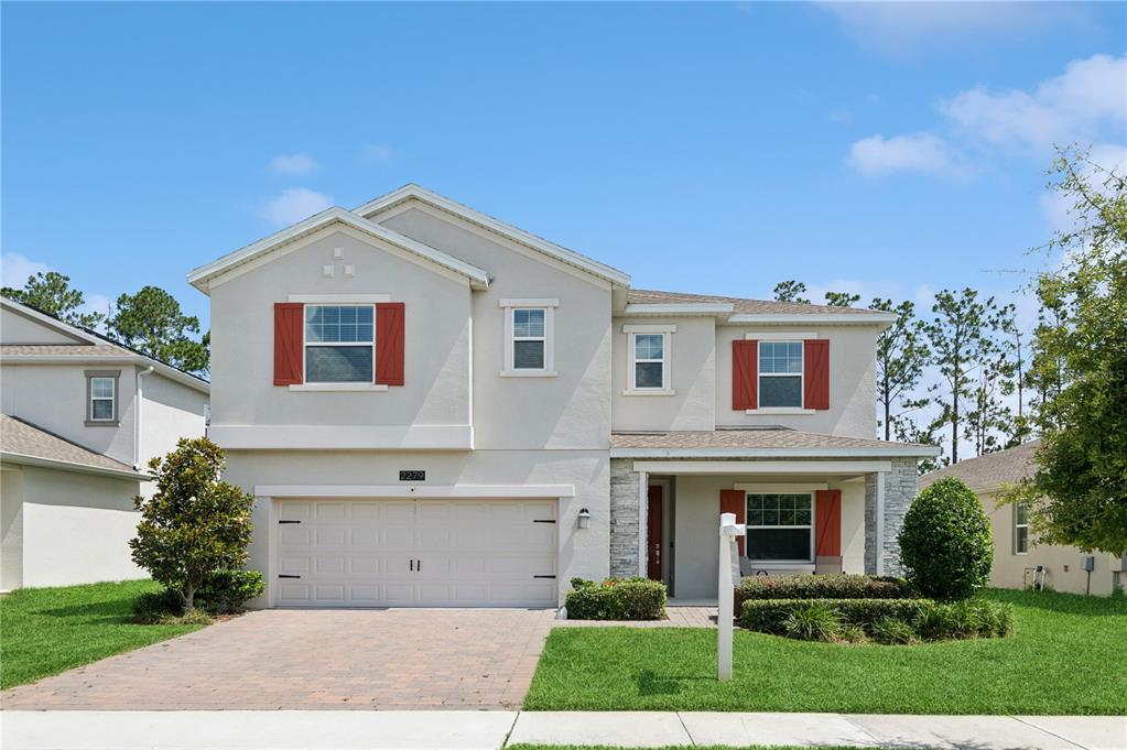 2279 Mountain Pine Street Ocoee, FL 34761 - Photo 1 of 1 a view of a white house with a small yard and a large tree