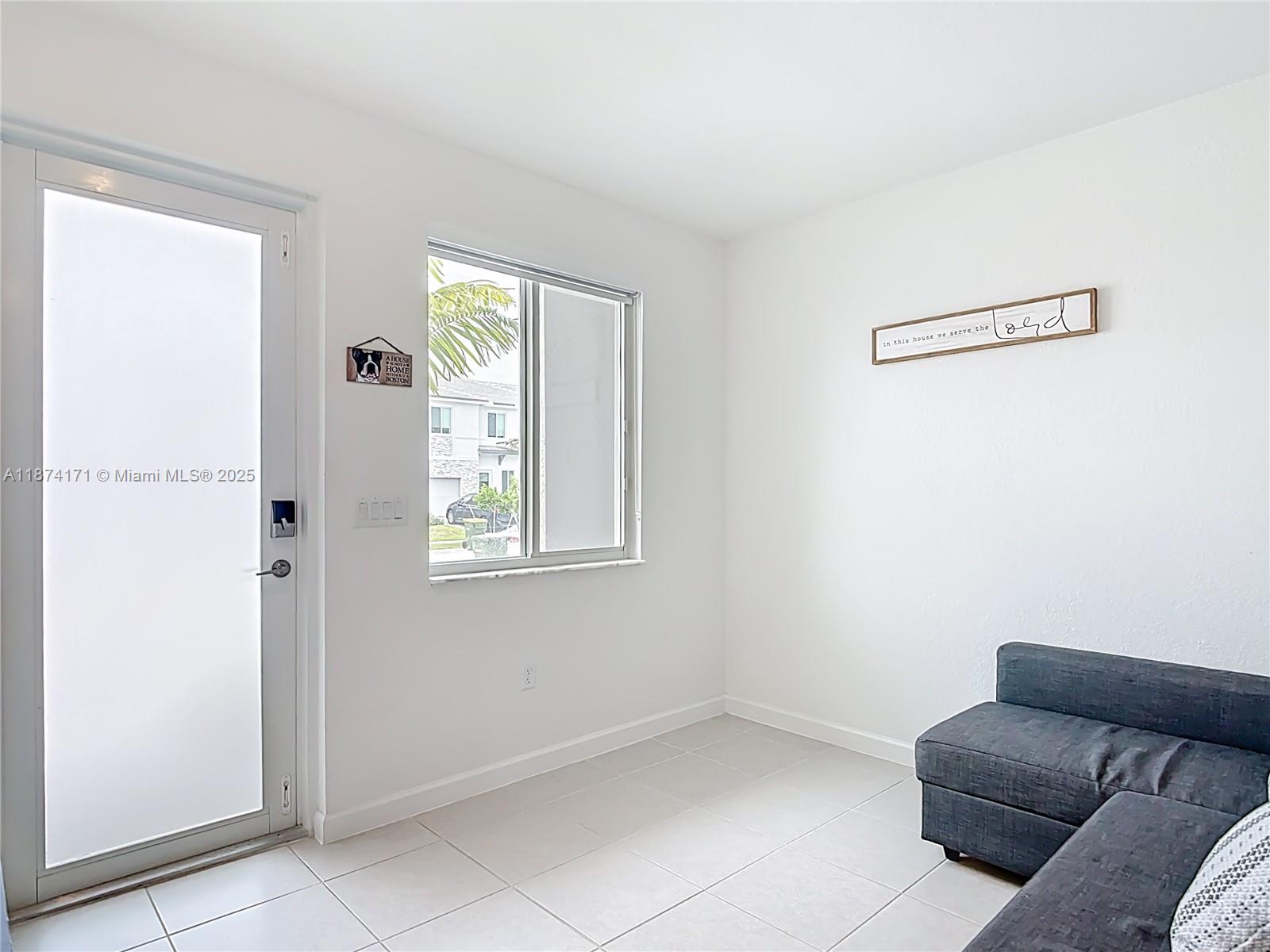 716 Southeast 14th Street Homestead, FL 33034 - Photo 13 of 60 a living room with furniture and a window