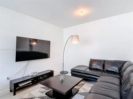a view of a livingroom with furniture and window