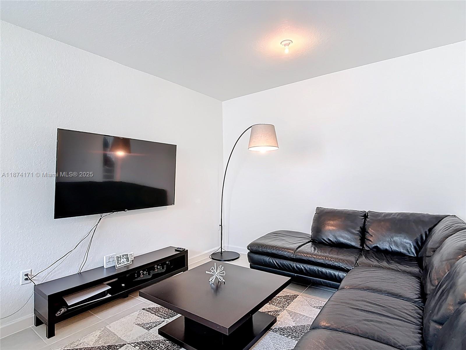 716 Southeast 14th Street Homestead, FL 33034 - Photo 15 of 60 a living room with furniture and a flat screen tv