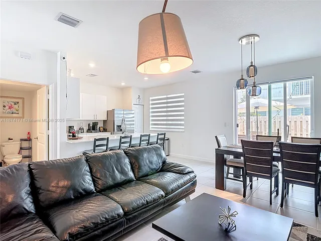 a view of a livingroom with furniture and a flat screen tv