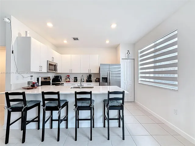 a kitchen with cabinets stainless steel appliances and counter space