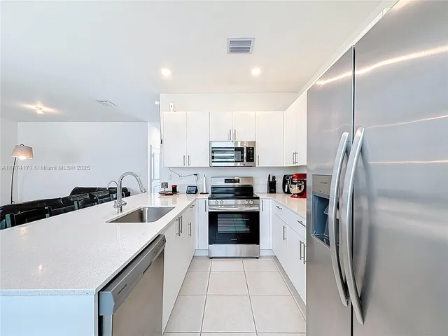 a view of staircase with white walls and a window