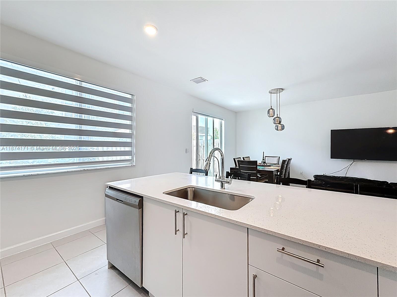 716 Southeast 14th Street Homestead, FL 33034 - Photo 25 of 60 a kitchen with a sink and a wooden floor