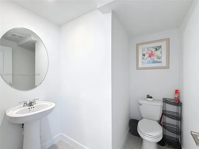 a bedroom with a bed and a flat tv screen on wall