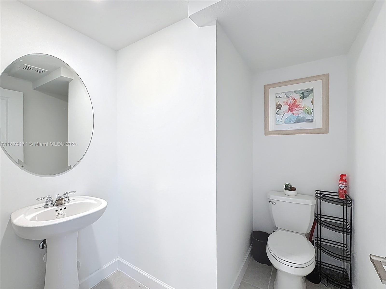 716 Southeast 14th Street Homestead, FL 33034 - Photo 26 of 60 a bathroom with a toilet sink and mirror