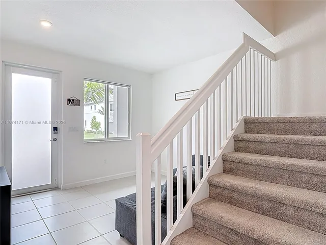 a bedroom with a bed and a night stand