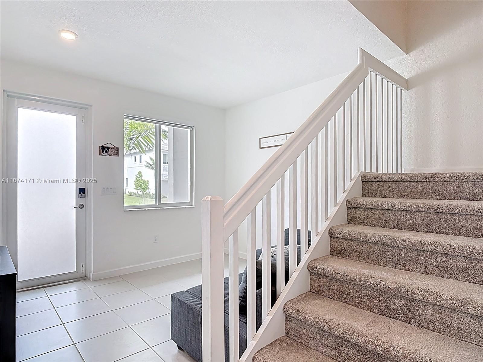 716 Southeast 14th Street Homestead, FL 33034 - Photo 27 of 60 a view of staircase with white walls and a window