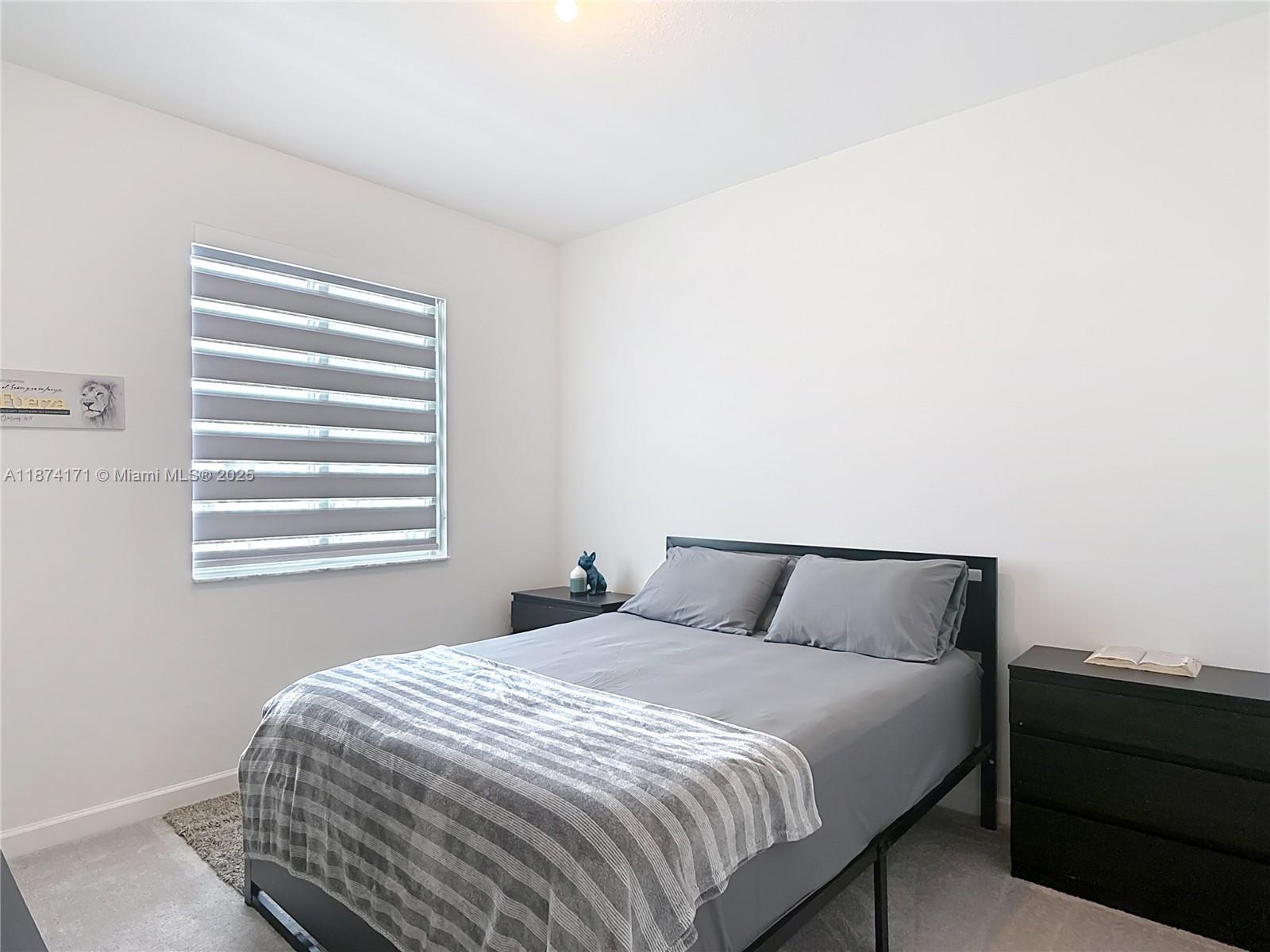 716 Southeast 14th Street Homestead, FL 33034 - Photo 32 of 60 a bedroom with a bed and window