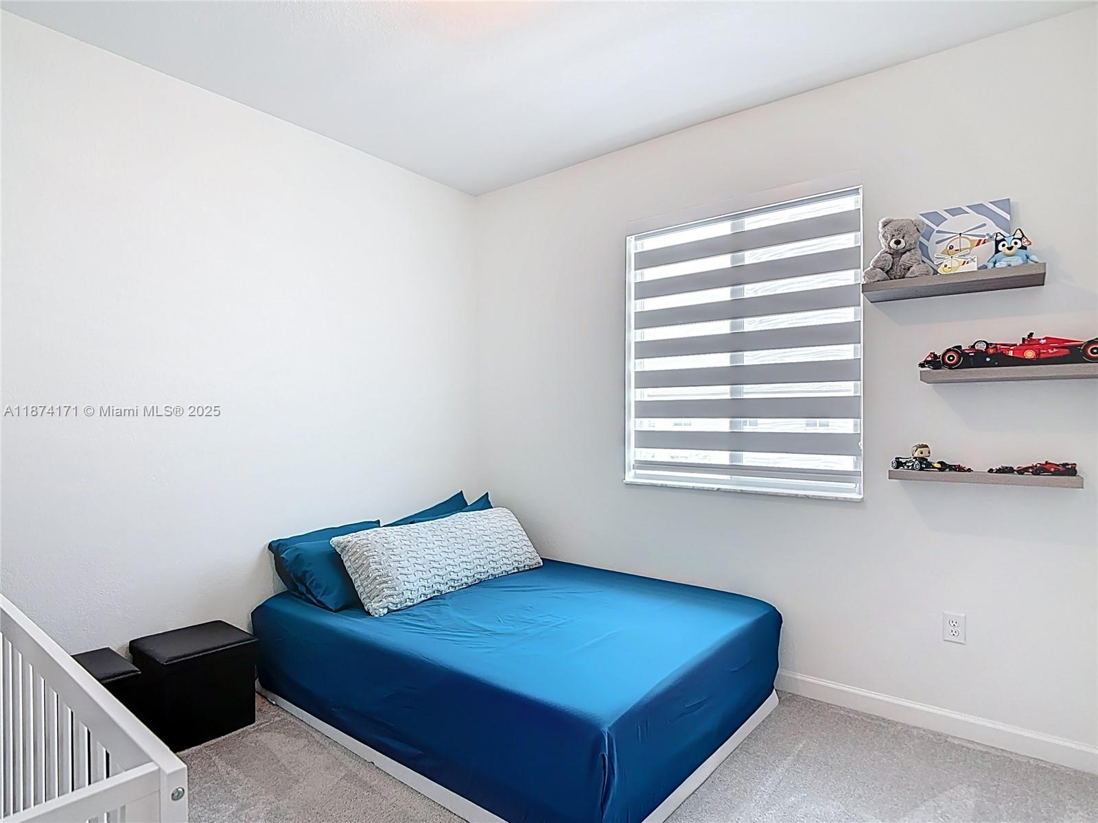 716 Southeast 14th Street Homestead, FL 33034 - Photo 34 of 60 a room with a bed and a window