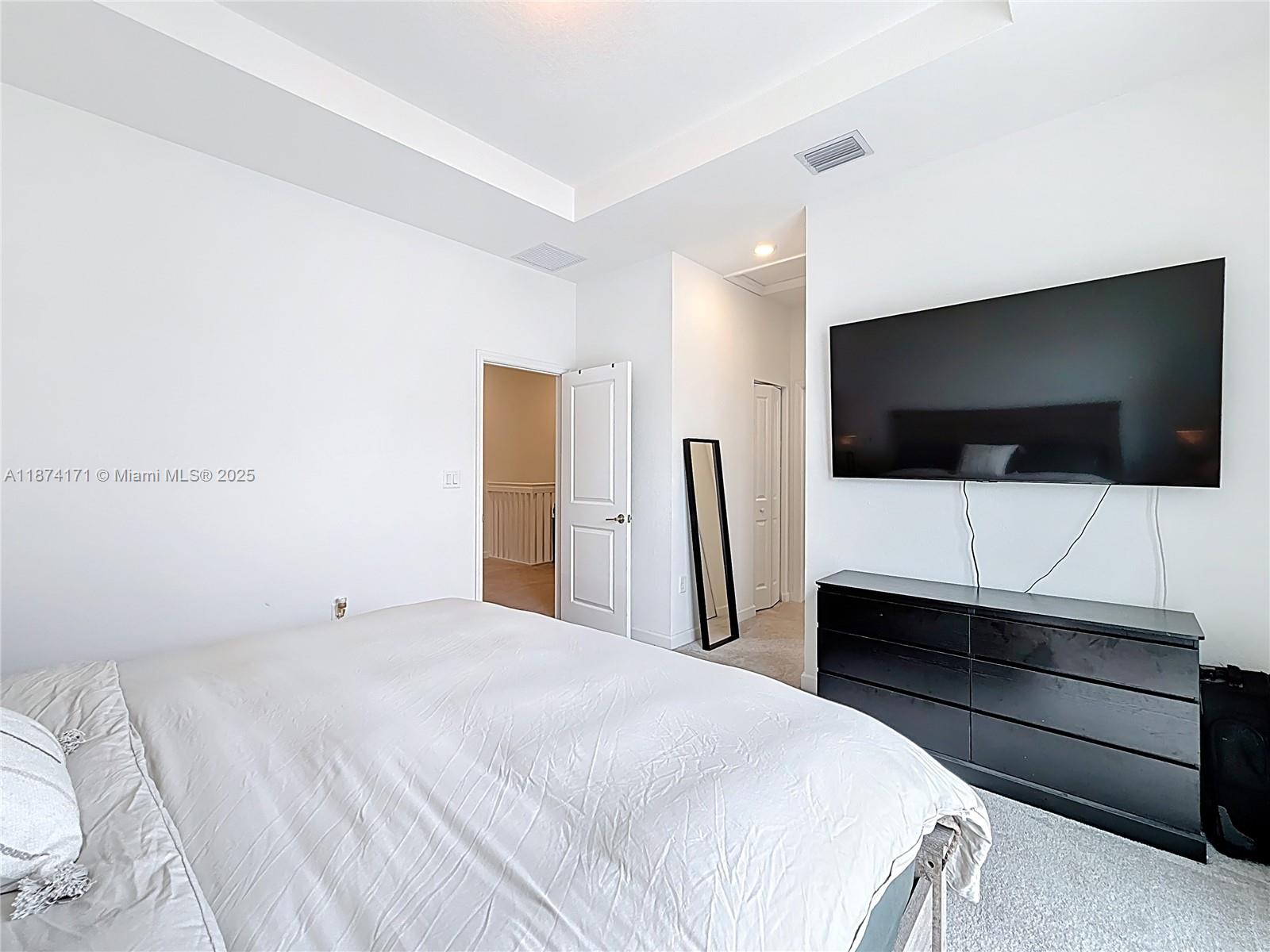 716 Southeast 14th Street Homestead, FL 33034 - Photo 37 of 60 a bedroom with a bed and a flat screen tv