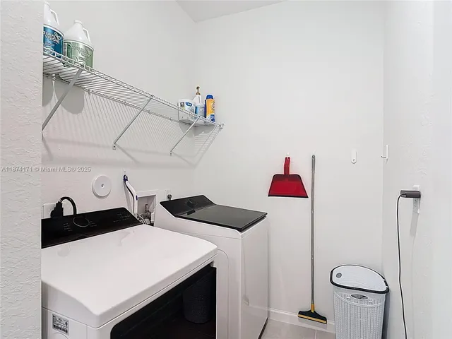 a view of a patio with table and chairs under an umbrella