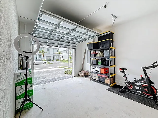 a view of a patio with a table and chairs under an umbrella