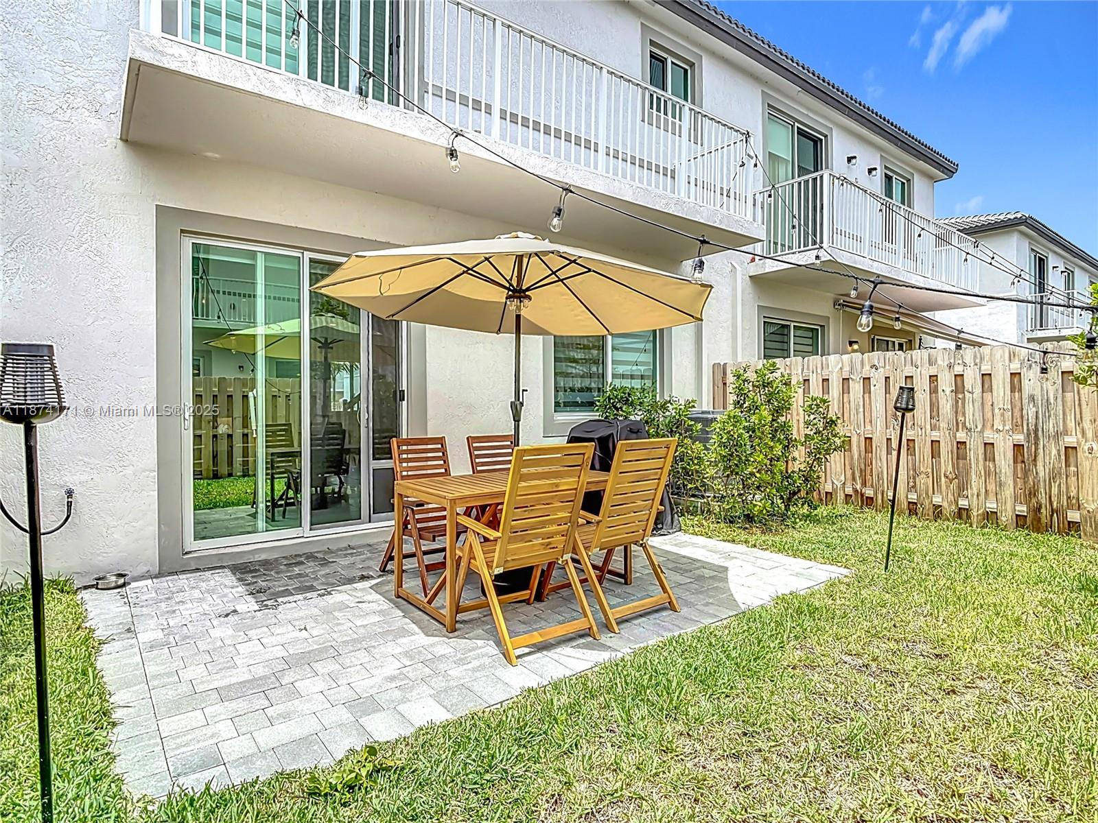 716 Southeast 14th Street Homestead, FL 33034 - Photo 49 of 60 a patio with a yard table and chairs