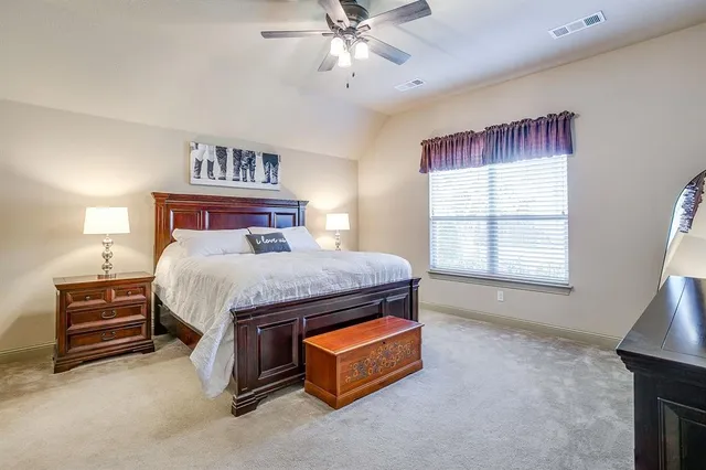 a bed sitting in a room next to a window