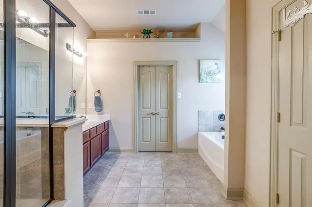 a bathroom with a granite countertop sink mirror and bathtub