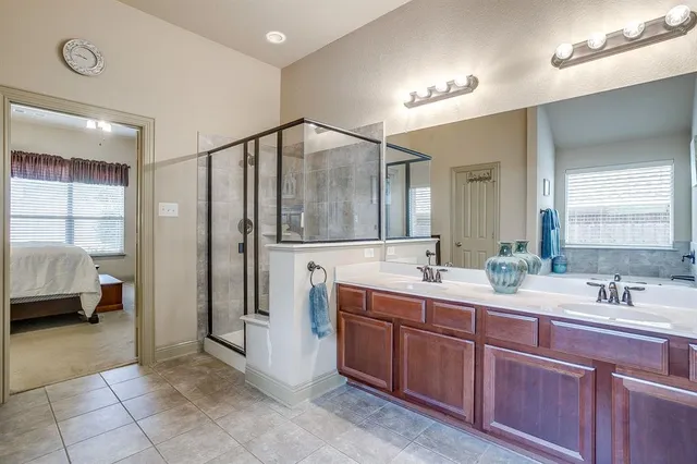 a spacious bathroom with a double vanity sink and a mirror