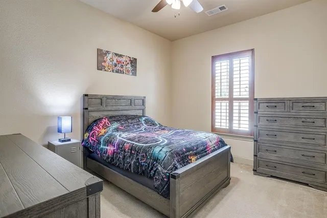 a bed sitting in a bedroom next to a window