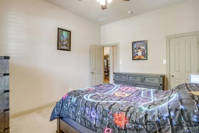 a bedroom with a bed and a painting on the wall