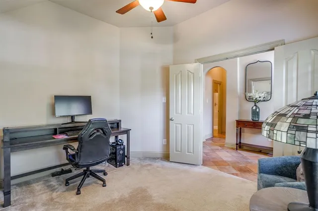 a view of a livingroom with workspace and a window