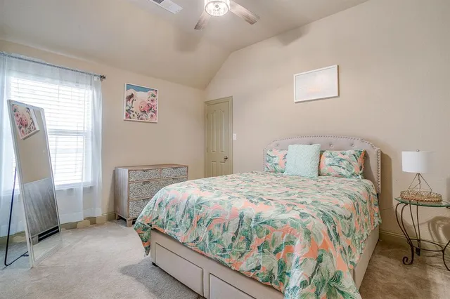 a bedroom with a bed and window