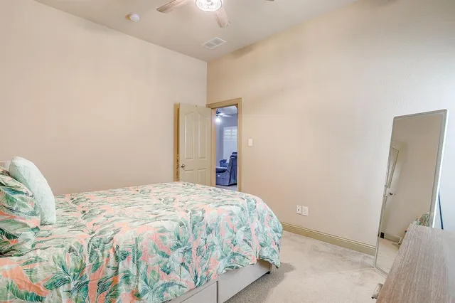 a bedroom with a bed and a mirror