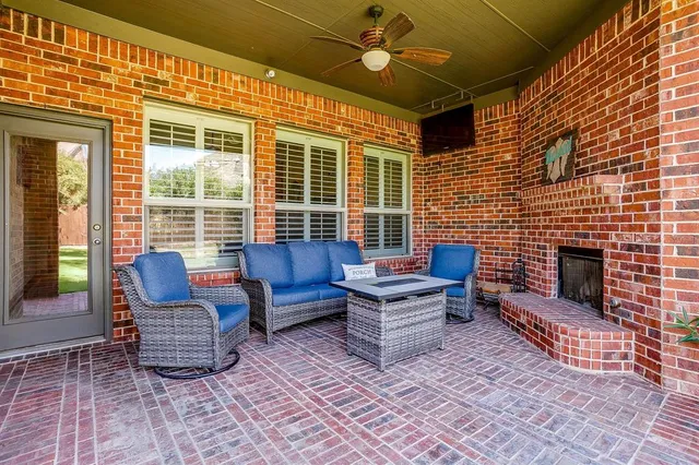 a outdoor living space with patio furniture and a fireplace