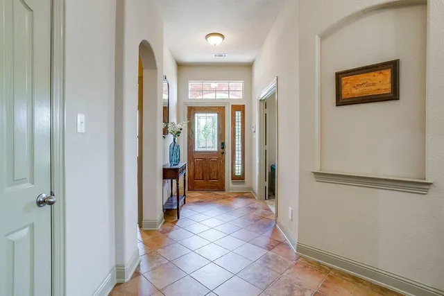 a view of a hallway with wooden shelves