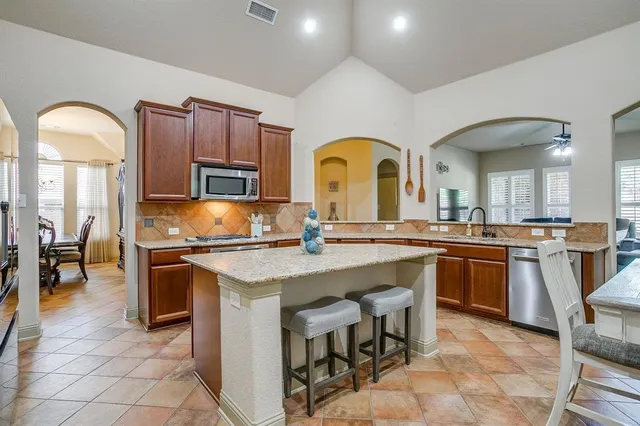 a kitchen with cabinets a sink and appliances