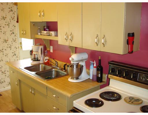 1938 Maratta Road Aliquippa, PA 15001 - Photo 2 of 8 Kitchen. Kitchen Includes Electric Stove and Refrigerator. Door Pictured Leads to Backyard. Past the Door is the Laundry Room.