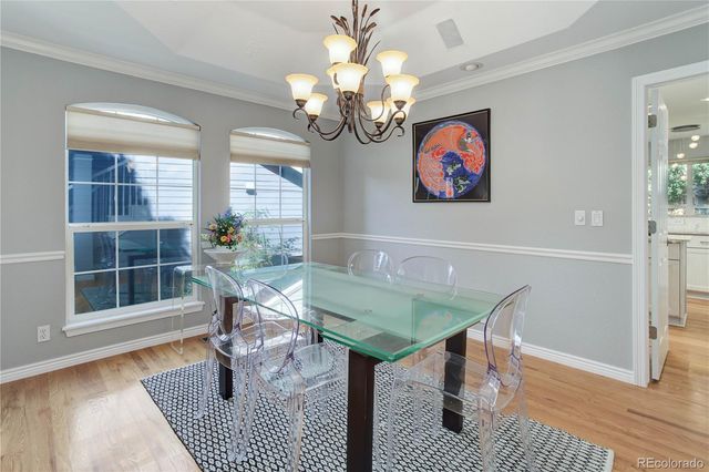a view of a dining room with furniture wooden floor and chandelier