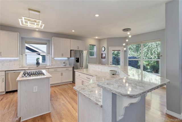 a kitchen with counter top space sink stove and refrigerator