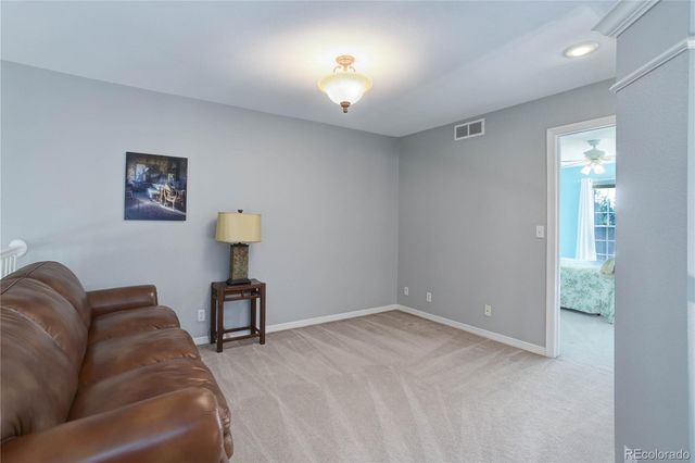 a living room with furniture and a lamp