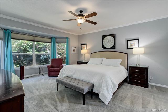 a bedroom with a large bed and a large window