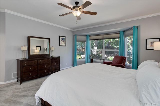 a bedroom with a large bed and a large window