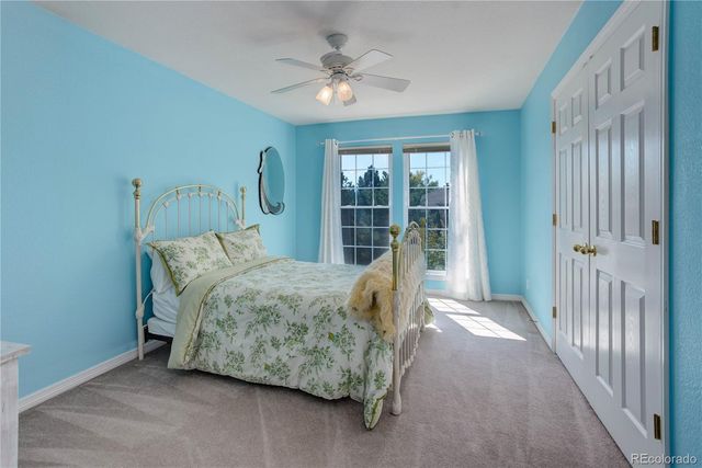 a bed sitting in a room next to a large window