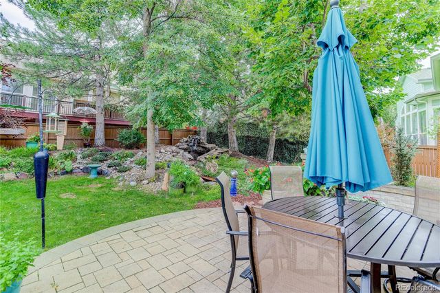 a view of a backyard with furniture and a garden
