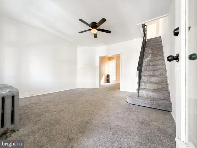 an empty room with windows and entryway