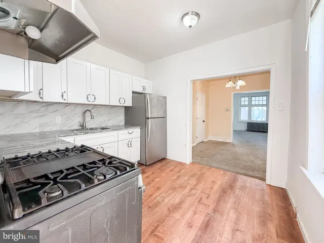 a kitchen with stainless steel appliances granite countertop a stove and a refrigerator