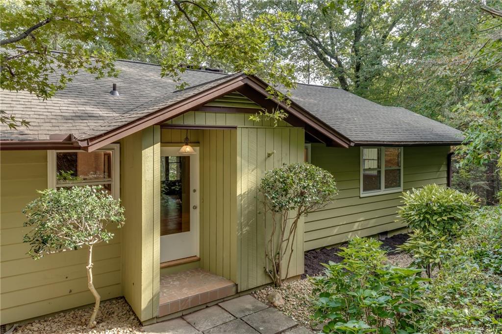 81 Jericho Drive Tryon, NC 28782 - Photo 2 of 23 a front view of a house with garden