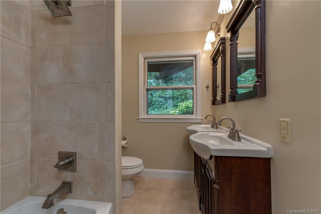 81 Jericho Drive Tryon, NC 28782 - Photo 13 of 23 a bathroom with a sink a toilet and a mirror
