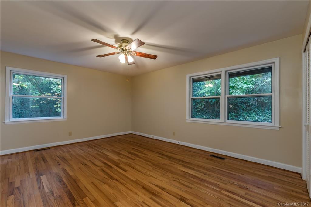 81 Jericho Drive Tryon, NC 28782 - Photo 14 of 23 a view of empty room with wooden floor and fan